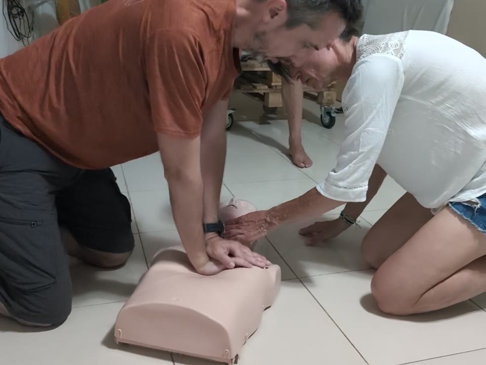 Students practising CPR with instructor supervision
